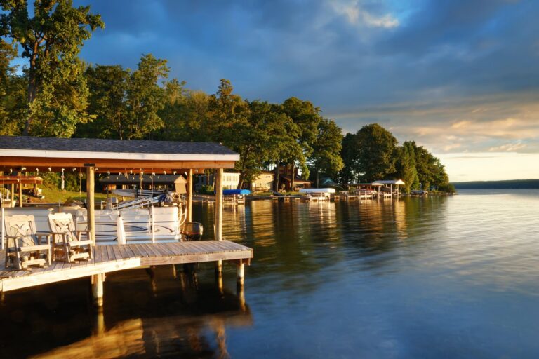 Lakefront homes and boat docks at sunset